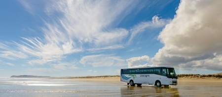 a bus that is parked on the beach