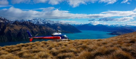 a blue and white plane sitting on top of a mountain