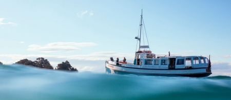 a blue and white boat floating on a body of water