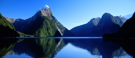 a body of water with Milford Sound in the background