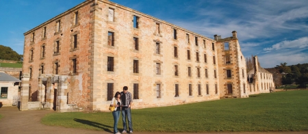 a person standing in front of a brick building