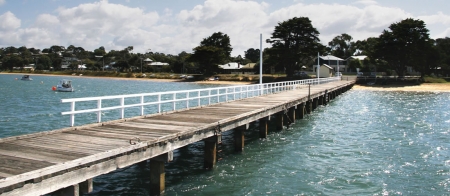 a wooden pier next to a body of water