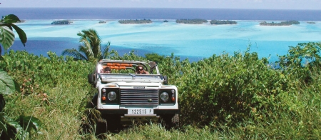 a truck is parked in front of a body of water