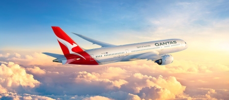 a large passenger jet flying through a cloudy blue sky