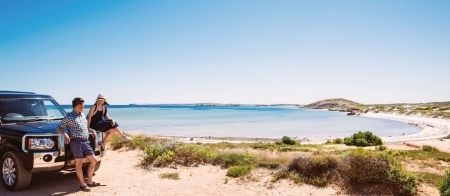 a man standing next to a body of water