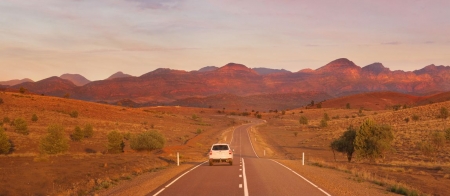 a highway with a mountain in the background