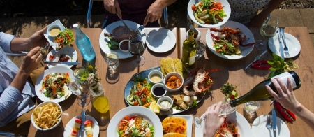 a group of people sitting at a table with a plate of food