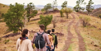 a man and a boy walking down a dirt road