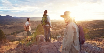 a group of people standing on top of a mountain