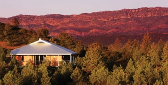 a house with a mountain in the background