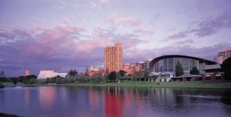 a large body of water with a city in the background