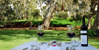 a group of people sitting at a table with wine glasses