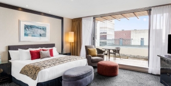 a bedroom with a large bed in a hotel room