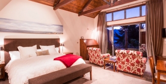 a bedroom with a large red chair in a room