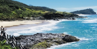 a person standing on a rocky beach