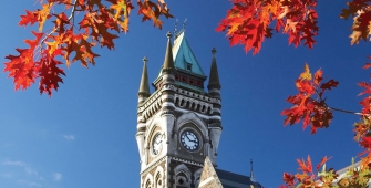 a large tall tower with a clock at the top of a building