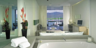 a large white tub sitting next to a sink