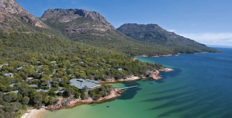 a large body of water with a mountain in the background