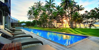 a pool next to a palm tree