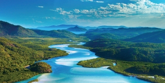 a body of water with a mountain in the background