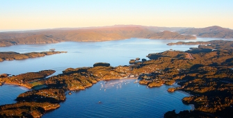 a body of water with a mountain in the background