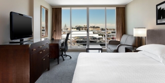 a bedroom with a large bed in a hotel room