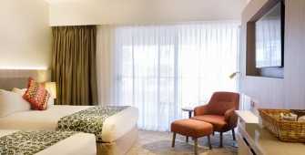 a hotel room filled with furniture and a large window