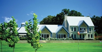 a house on top of a lush green field