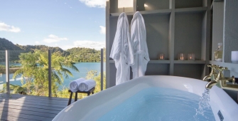 a large white tub sitting next to a window