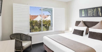 a hotel room with a bed and chair