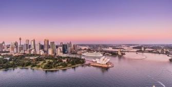 a body of water with a city in the background