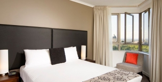 a bedroom with a large bed in a hotel room