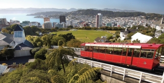 a passenger bus that is parked on the side of Wellington Cable Car