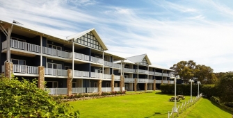 a large building with a grassy field