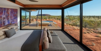 a bedroom with a bed and a large window