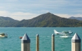 a small boat in a body of water with a mountain in the background