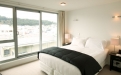 a hotel room with a large bed in a bedroom next to a window