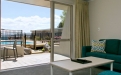 a hotel room with a pool in front of a window