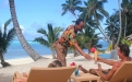 a person sitting in front of a palm tree