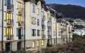 a large white building with a mountain in the background