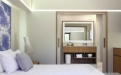 a bedroom with a bed and a mirror