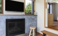 a fire place sitting in a living room with a television and a fireplace
