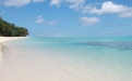 a sandy beach next to a body of water