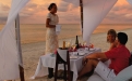 a man and a woman sitting at a beach