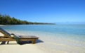 a wooden bench sitting next to a body of water