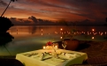 a boat sitting on top of a table next to a body of water