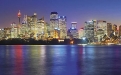 a body of water with a city in the background