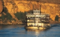 a boat in the water with a mountain in the background