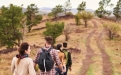 a man and a boy walking down a dirt road