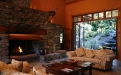 a stone fireplace in a living room filled with furniture and a fire place